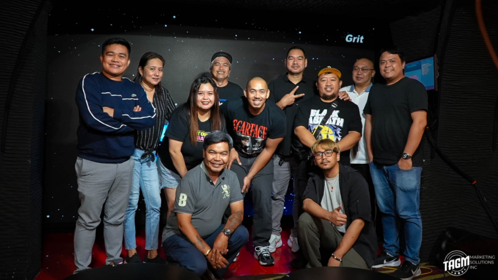 The KwentuJuan Podcast production crew smiling and sharing drinks with comedian James Caraan at The KoolPals Bar.