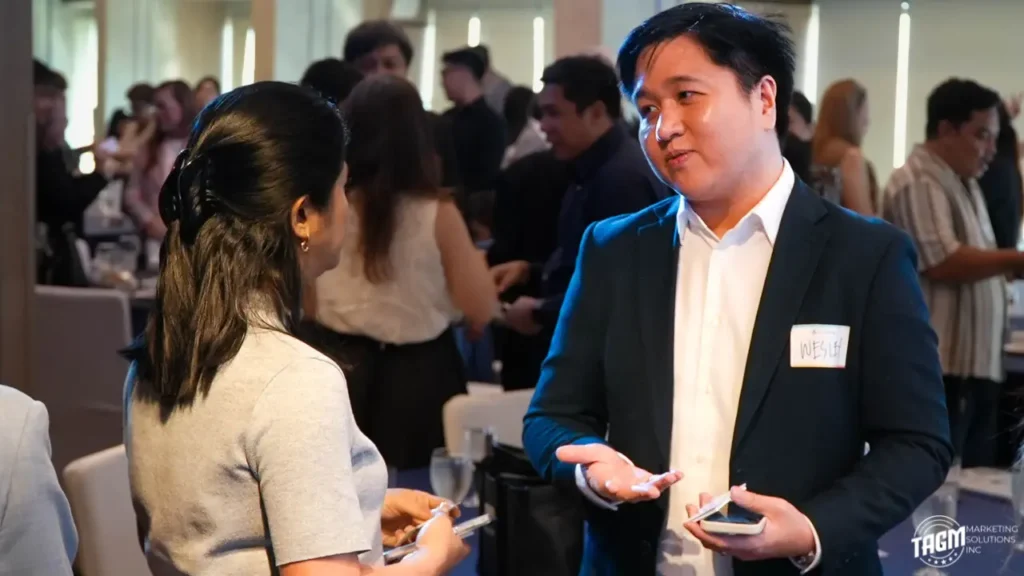 The team from TAGM Marketing Solutions Inc smiling and networking during the PMA Summer Dine and Wine Fellowship event at The Bellevue Hotel in Alabang.